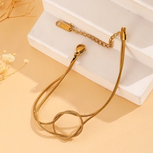 Detail of gold snake chain bracelet with lobster clasp and adjustable extension chain