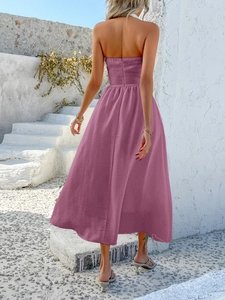 Rear view of purple halter neck maxi dress featuring textured fabric and open back design