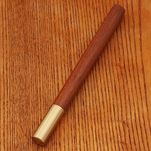 Close-up of retro bamboo brass pen showcasing high-quality rosewood and metal texture