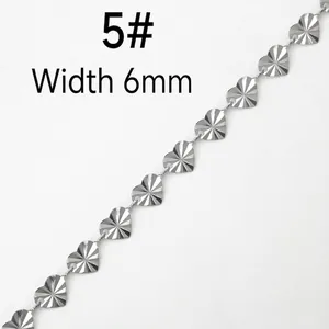 Detail of 6mm heart shaped stainless steel chain links with radial cut surface finish