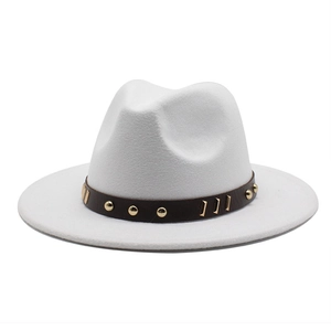 Dettaglio del cappello in lana bianca con cintura in pelle marrone e borchie dorate