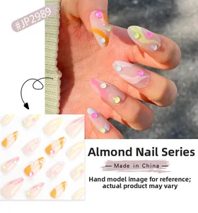 Short almond press-on nails featuring pink and orange wavy patterns with tiny colorful rhinestones