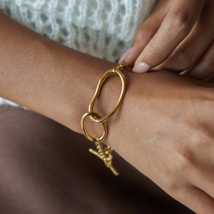 Detailed close-up of golden stainless steel irregular link bracelet with an OT clasp