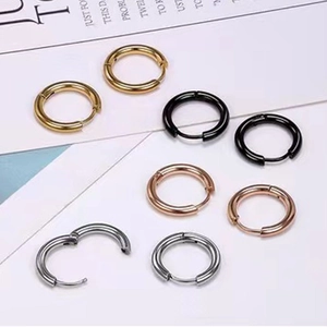 Flat lay of high-quality stainless steel hoop earrings in four metallic colors