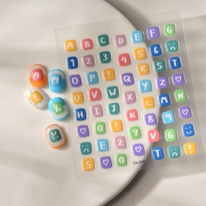 Macro view of 3D embossed colorful alphabet and number nail art stickers on a white plate