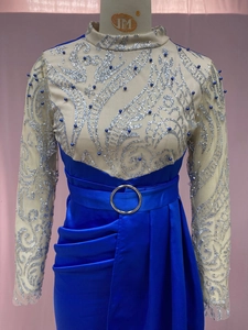 Detail of blue evening gown with silver sequins, blue pearls and satin pleated slit skirt