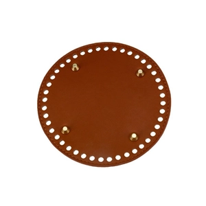 Brown round leather bag base with pre-punched holes and four gold metal feet for DIY projects