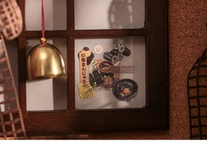 Close-up of vintage Japanese food stickers with mini bell on a miniature wooden window
