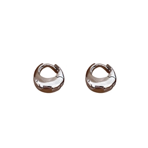 Minimalist silver bean hoop earrings with high-polish metallic finish on white background