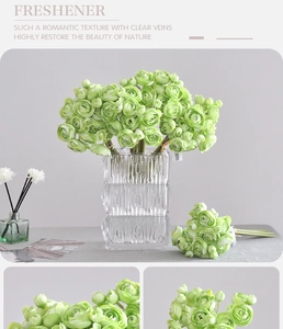 Detail view of artificial light green Ranunculus flowers in a stylish glass vase decor