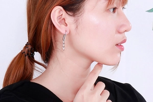 Silver chain drop earrings for women with minimalist metallic link design on model