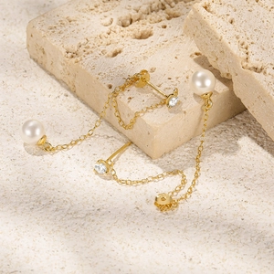 Macro detail of S925 sterling silver stamp on gold pearl tassel drop earrings