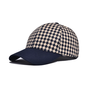Detail view of navy blue houndstooth pattern and structured brim on baseball cap