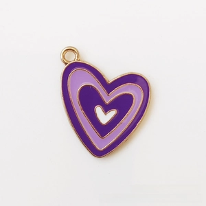 Close-up of heart-shaped charm with purple enamel and golden metal edge for DIY jewelry