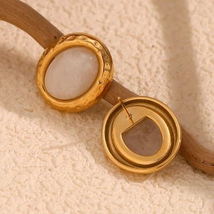 Macro view of 18K gold plated hammered texture earrings with oval natural stones