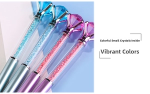 Macro shot of diamond-topped pens with colorful crystal fillings and metallic finishes