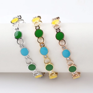 Close-up of three-tone stainless steel bangles with colorful enamel and zircon details