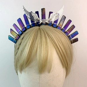 Macro detail of silver wings and gradient crystal shards on bridal crown headband