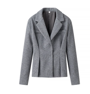 Détails de la texture en laine peignée grise sur l'ensemble blazer cintré et jupe