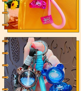 Close-up of metallic bear keychains in pink, blue and silver with braided wrist straps