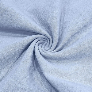 Macro detail of sky blue linen blend fabric texture showing breathable plain weave pattern