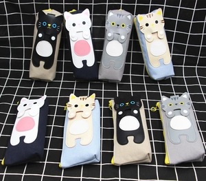 Flat lay showing creative cat-themed canvas pencil cases in various cute colors