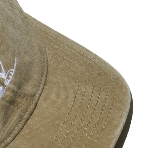 Macro detail of khaki sun hat with reinforced six-line stitching and soft cotton texture