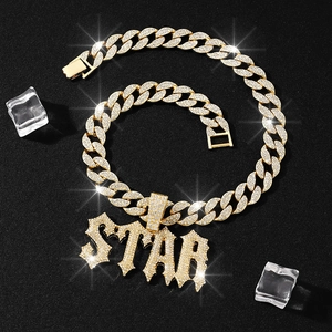 Iced out gold STAR pendant necklace with Cuban chain set against dark ice backdrop