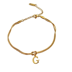 Gold stainless steel snake chain bracelet with letter G pendant and lobster clasp detail