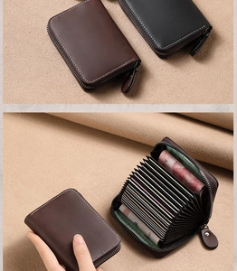 Detail of leather card holder showing zipper closure and accordion multi-slot interior