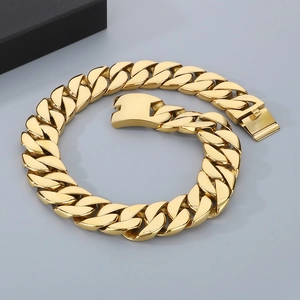 31mm gold chunky Cuban link chain necklace with secure clasp for men on grey background