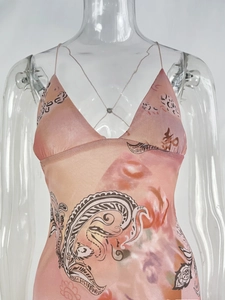 Close-up of pink mesh dress featuring V-neck straps and paisley artistic prints