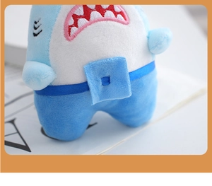 Detail of blue shark plush keychain showing white tooth embroidery and soft fabric texture
