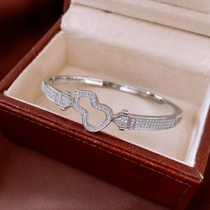 Close-up of a silver hollow gourd bangle with pave diamonds in a premium jewelry box