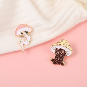 Detailed view of colorful mushroom girl enamel pins with golden metal edges on fabric