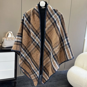 Detail of soft brown plaid scarf with thick texture and navy blue stitched edges