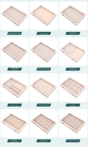 Detail view of jewelry boxes showing various internal grid layouts and glass lids
