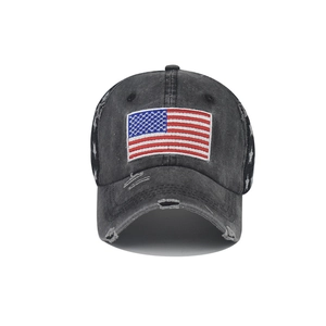 Detailed view of washed black cotton cap with US flag embroidery and distressed holes