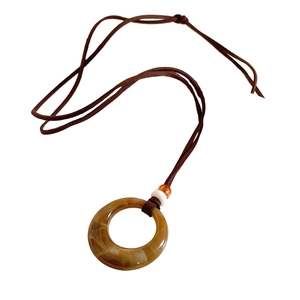 Vintage resin circular pendant necklace with white and orange beads on brown leather cord