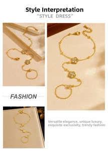 Macro shot of gold plated finger ring bracelet with zircon flower charms and lobster clasp