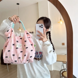 Close-up of pink tote bag featuring wavy texture and cute cartoon cat pattern