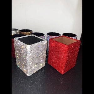 Detail of square crystal makeup brush holders in red and silver sparkling rhinestones