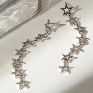 Macro shot of silver star chain earrings in stainless steel with a metallic luster finish