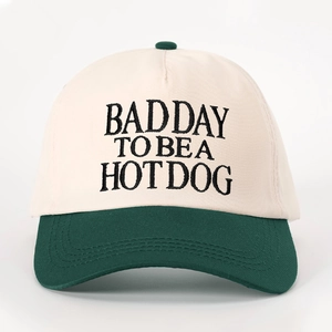 Retro baseball cap in cream and green with BAD DAY TO BE A HOT DOG embroidery