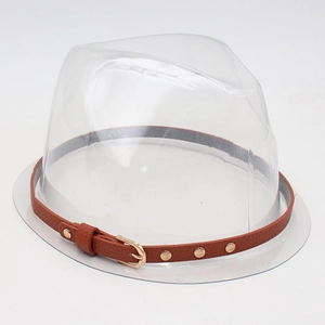 Detail of transparent hat stand base with a brown studded leather band and gold buckle