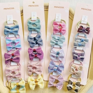 Close-up of pastel ribbon bow hair tie sets on display cards for girls and kids