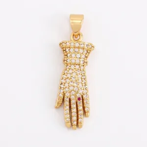 Detailed close-up of a gold-plated copper Hamsa hand pendant with white zircon micro-pave