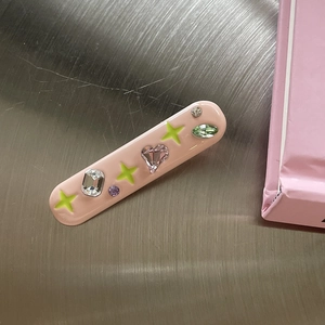 Pink rectangular hair clip with colorful gemstones and neon star patterns for women