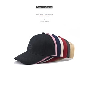 Detail view of cotton baseball caps in various colors including black pink and navy