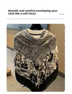Detail view of cotton linen shawl with black and white floral pattern hanging on a rack